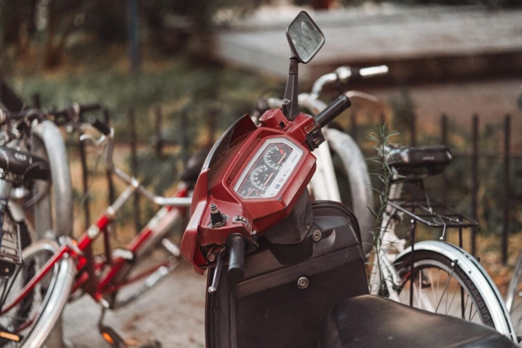 A commuter bike cockpit with a mirror and front light on a city street