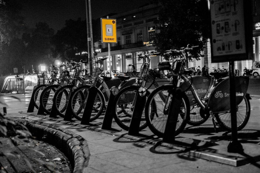 A commuter bike with front and rear lights on an evening city street