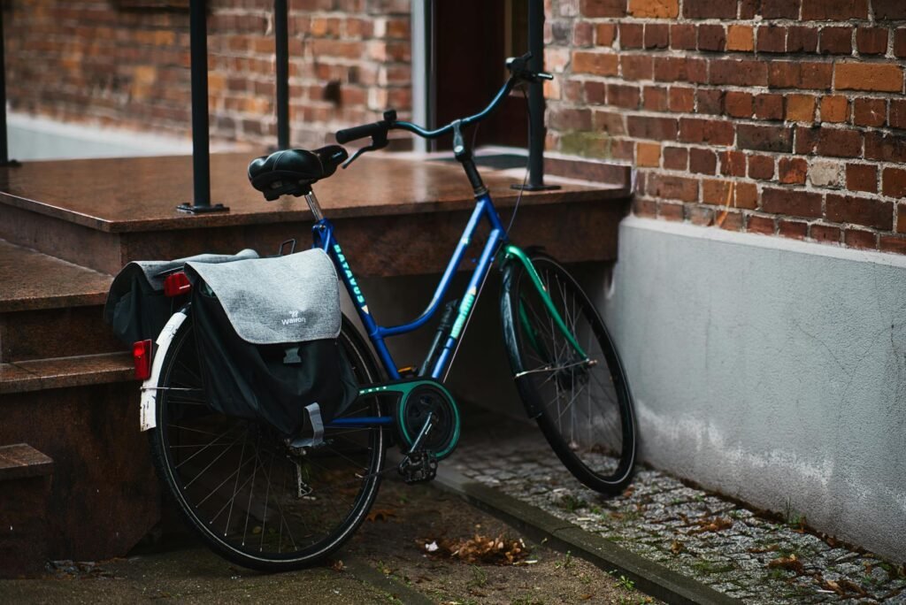 A rear rack and pannier attached to a commuter bike in a city setting.