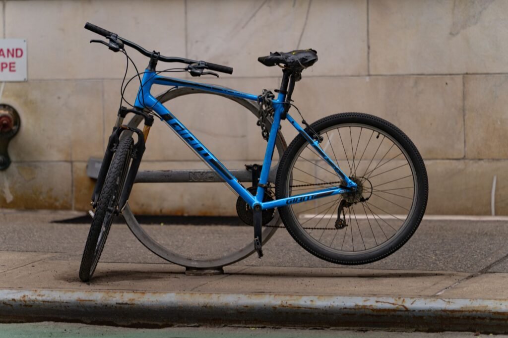 Commuter bike secured with a U-lock through the frame and rear wheel at a city bike rack