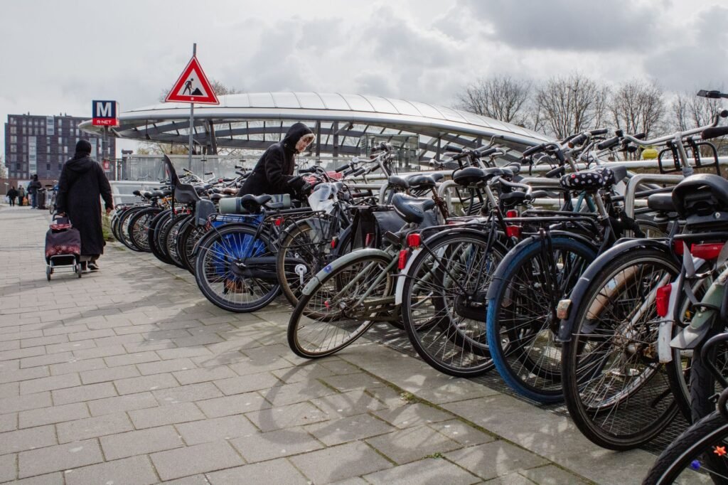 Person testing a public bike rack before locking a bicycle to it