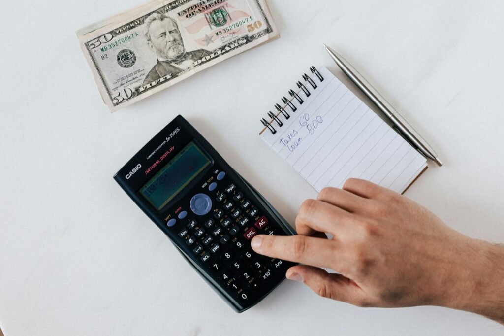 A calculator, parking receipts, a transit card, and a bike light laid out on a table.
