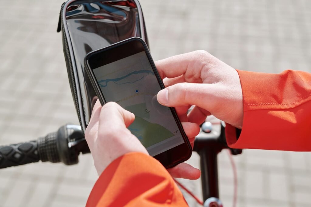 A city cyclist reviewing a route on a map with notes beside a helmet and coffee