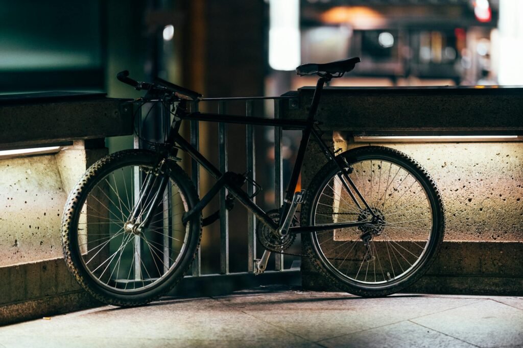 A commuter bike near an apartment doorway with a tape measure showing available space