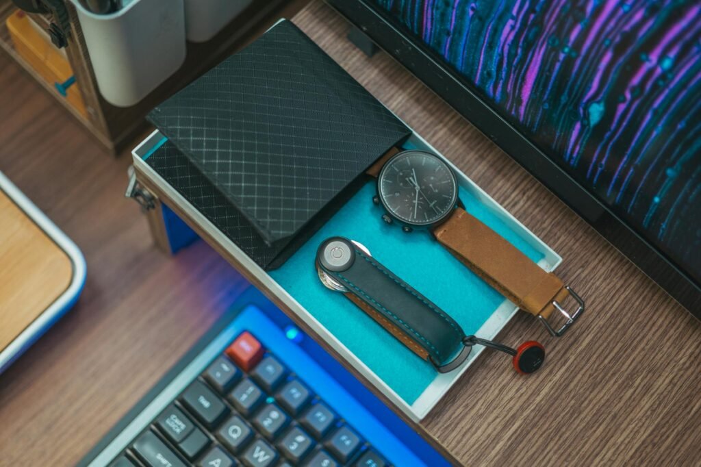 Bike commuting essentials organized on a desk next to a pannier and lights