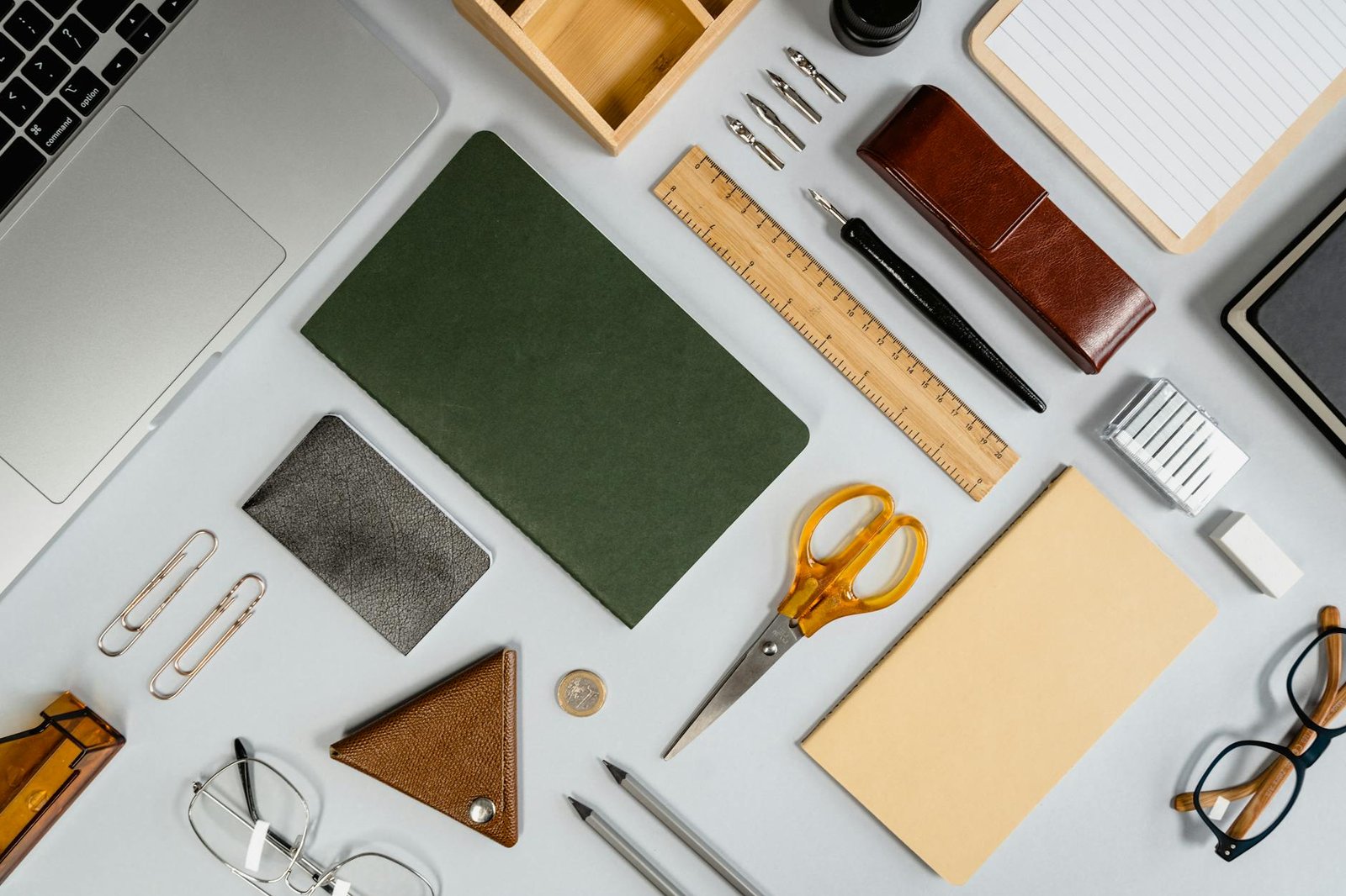 A tidy desk with a bike helmet, notebook, keys, and a packed pannier ready for a work commute.