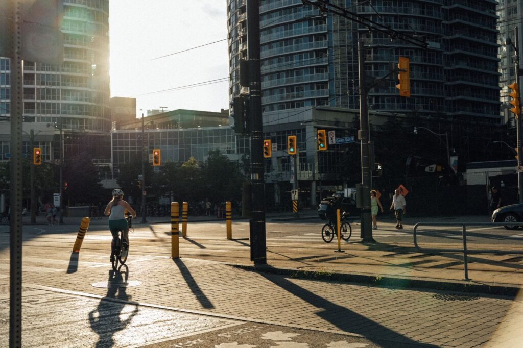 City cyclist waiting at an intersection with one foot down and the other on a pedal